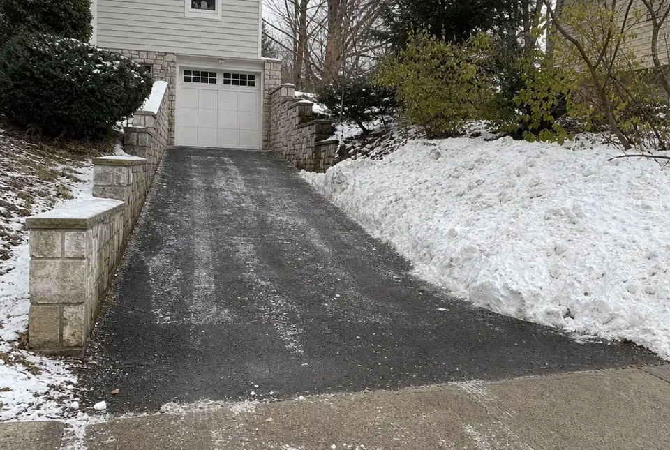 Freshly plowed steep driveway with the snow piled to one side