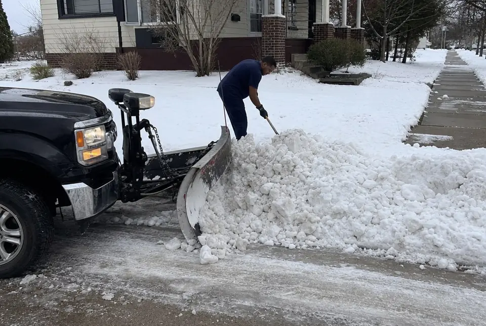 Plow blade clearing the street plow ridge at a narrow driveway
